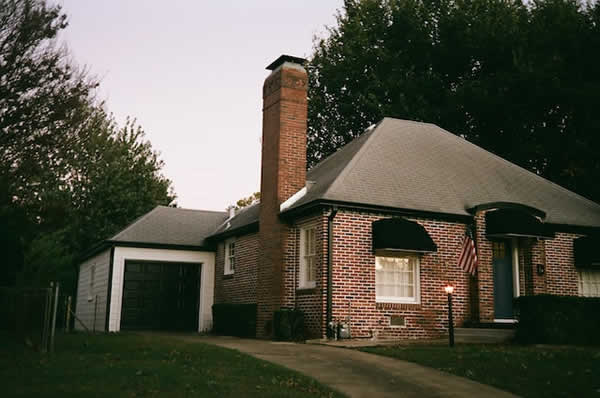 smaller home with large brick chimney