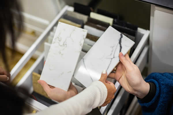 2 women looking at samples of quartz material